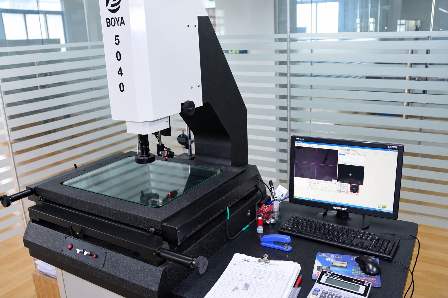 Attuale attrezzatura aziendale per il controllo dimensionale ottico e computer, ritoccata