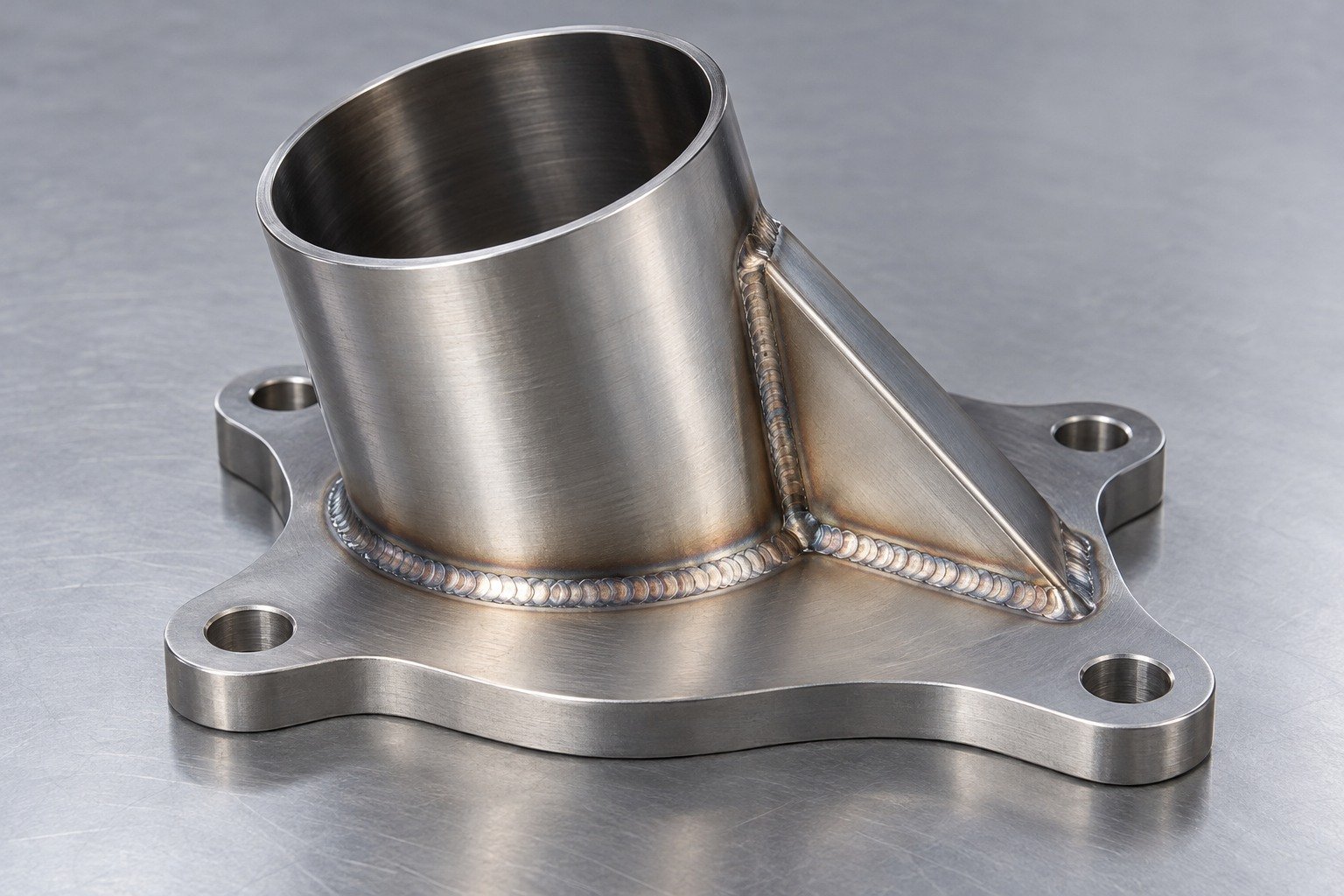 Short formed duct mounting assembly with flange and gusset — illustrative specialty stainless steel component concept
