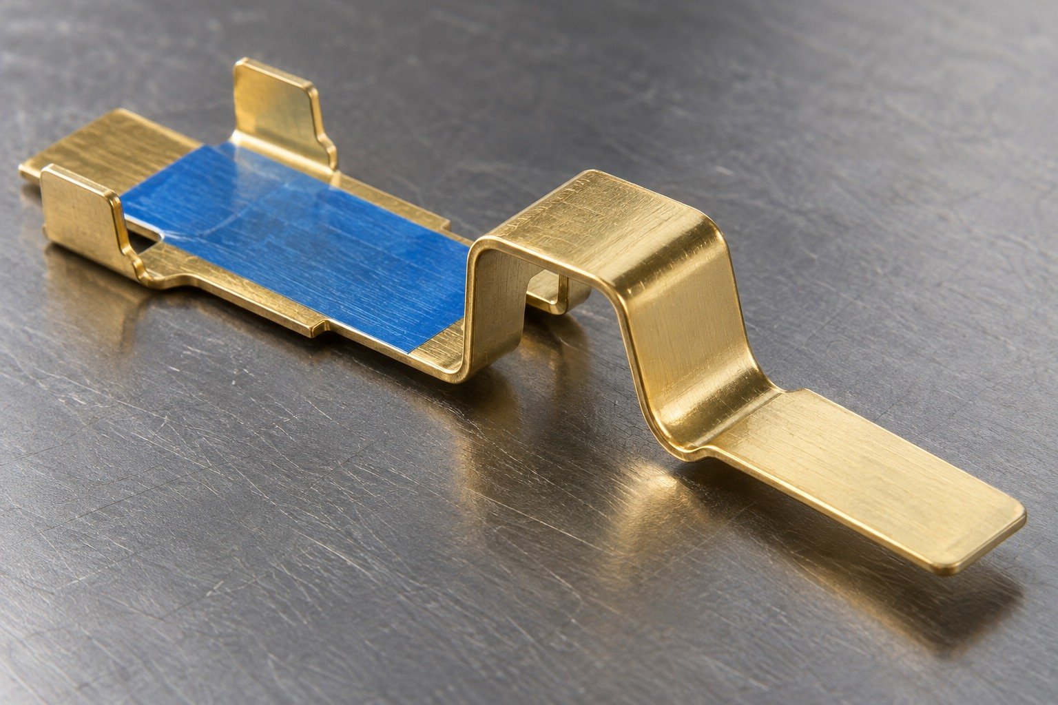 Working contact land and selected handling protection on a brass clip — illustrative generated component concept