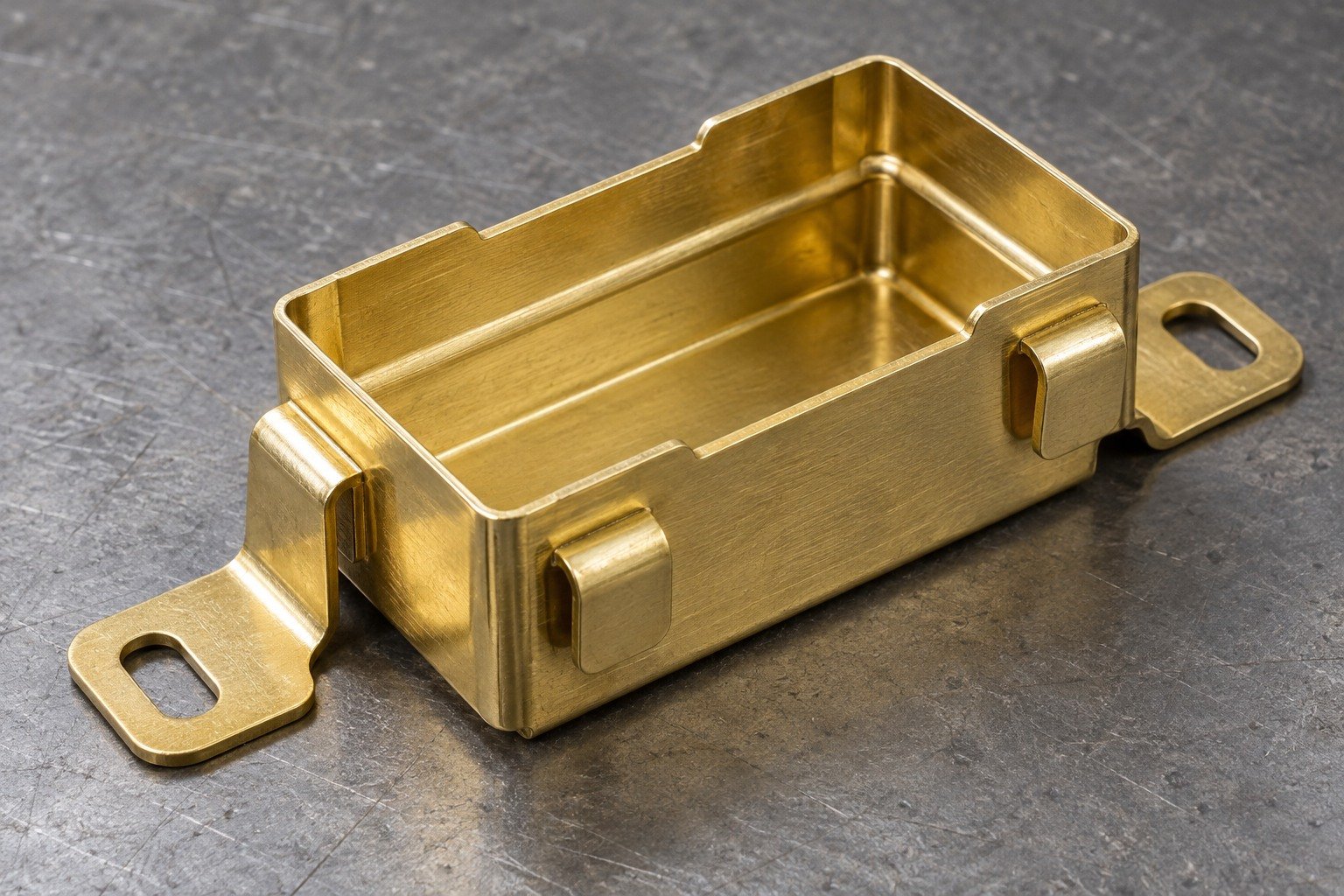 Illustrative thin formed brass connector enclosure with stepped rim and slotted mounting ears