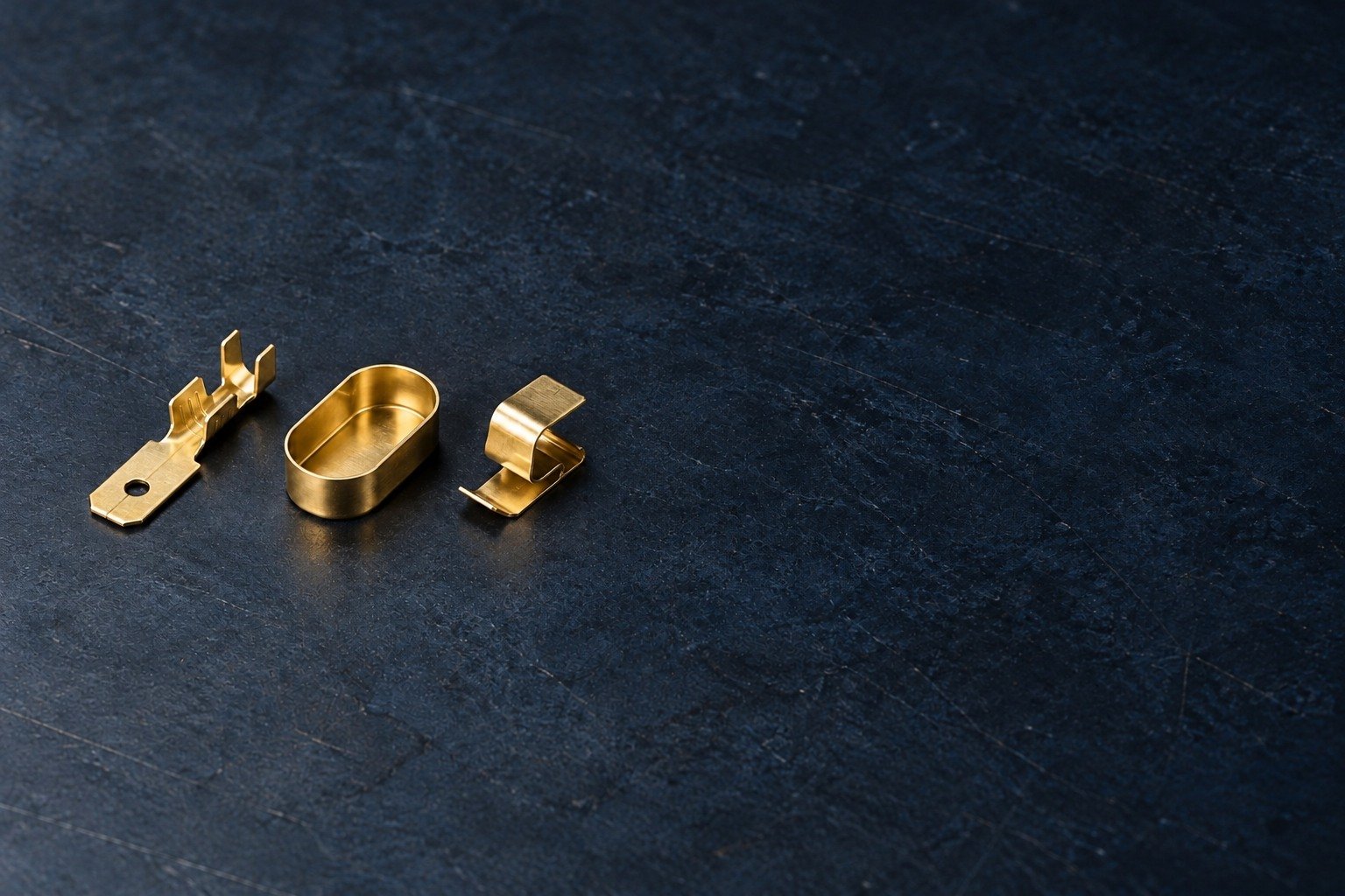 Thin brass terminal tab, shallow drawn enclosure cup and formed contact clip concepts — illustrative generated component concept