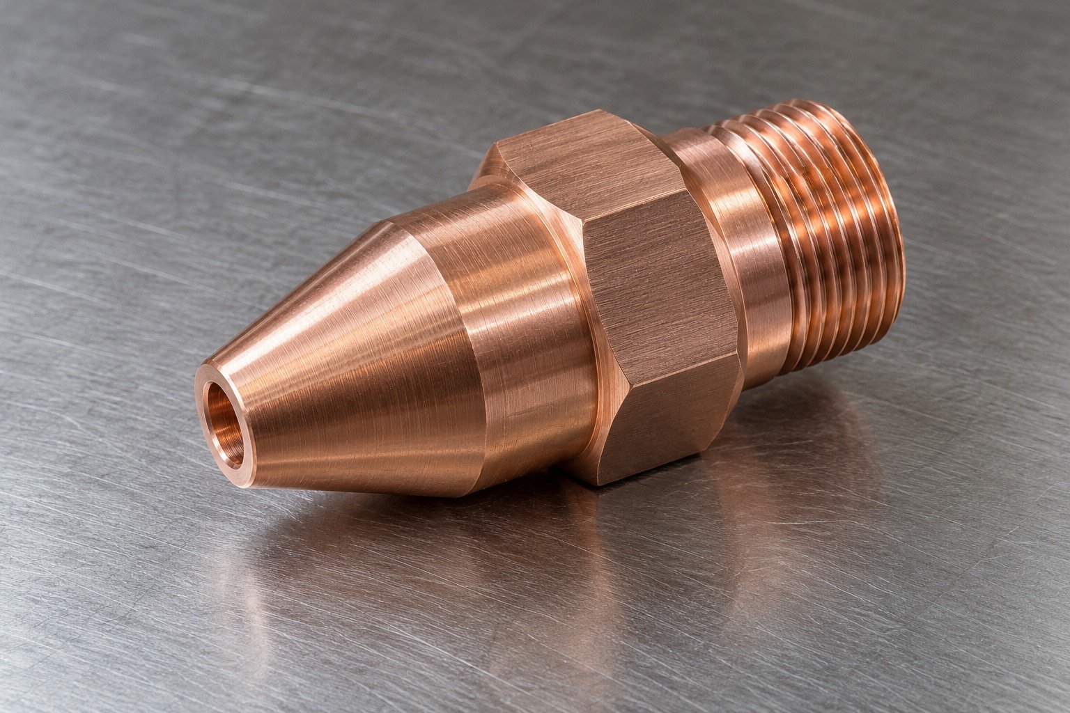 Studio industrial macro product photo of a single salmon copper turned nozzle body with hexagonal shoulder and fine external thread — illustrative generated component concept