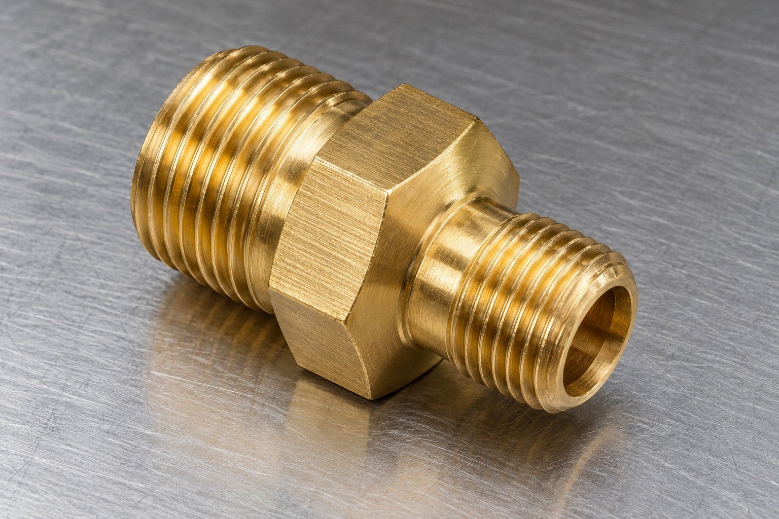 Studio industrial macro product photo of a single yellow brass short octagonal threaded adapter with two different diameter port ends — illustrative generated component concept