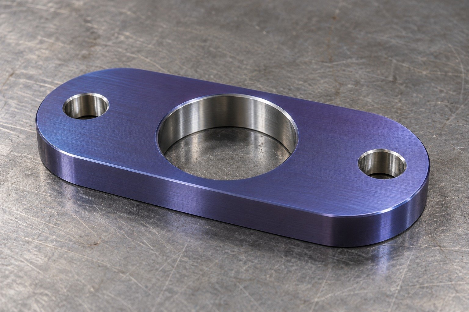 Distinct titanium obround mounting plate with muted violet-blue anodized appearance and bright masked bore surfaces,appearance concept only. — illustrative generated component concept